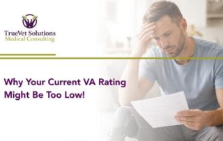 Veteran reviewing VA disability rating paperwork at home.